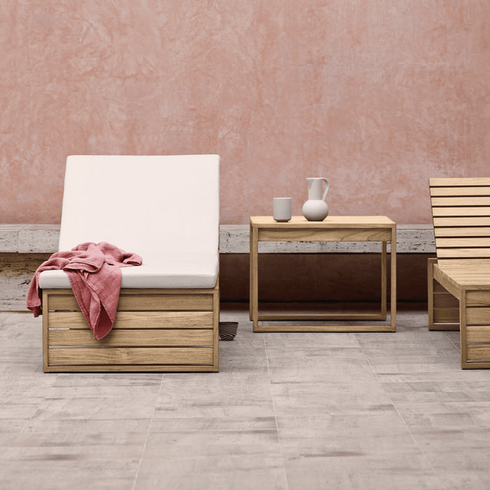Two Cubist Chaise Loungers agains a powder pink wall.