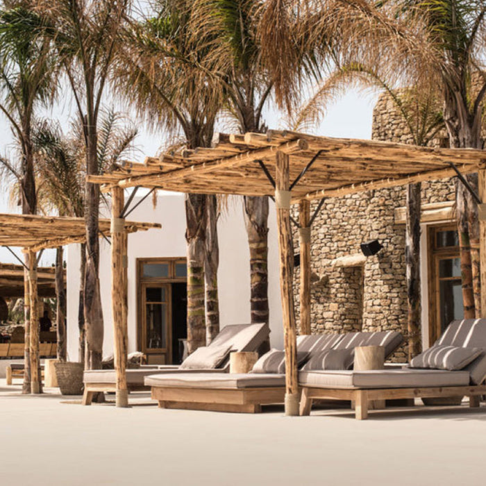 Mediterranean Beach Club outdoor furniture with chaise lounges.