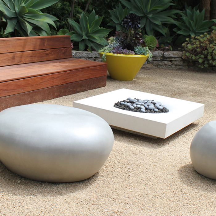 Boxhill's garden pebble seat and table are the perfect blend of form and function in this zen patio space. 