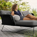 Boxhill's Horizon Outdoor Daybed lifestyle image with a woman lying down 
