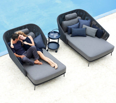 Boxhill's Mega Modern Outdoor Left Module Daybed lifestyle image with Mega Modern Outdoor Right Module Daybed and a couple sitting down showing affection beside the pool
