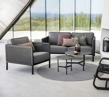 Boxhill's Encore Outdoor Single Seater Grey Sofa lifestyle image with Encore 2-Seater Sofa and 2 round table at the center