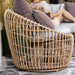 Boxhill's Nest Round Rattan Chair lifestyle image with pillows on top at patio