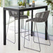 Boxhill's Drop Outdoor Bar Table Lava Grey lifestyle image with Breeze Bar Stackable Chair beside glass wall
