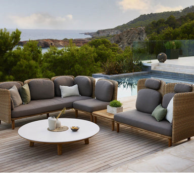 Boxhill's Arch Outdoor Corner Sofa w/ Teak Coffee Table 2 lifestyle image beside the pool