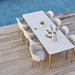 Boxhill's Choice Outdoor Dining Chair Teak Legs lifestyle image with Aspect Dining Table beside the pool