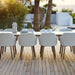 Boxhill's Choice Outdoor Dining Chair Teak Legs lifestyle image with Aspect Dining Table on wooden platform