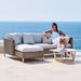 Boxhill's Connect Right Sectional Lounge Chair lifestyle image with Connect 2-Seater Left Module Sofa beside the pool with a woman sitting down