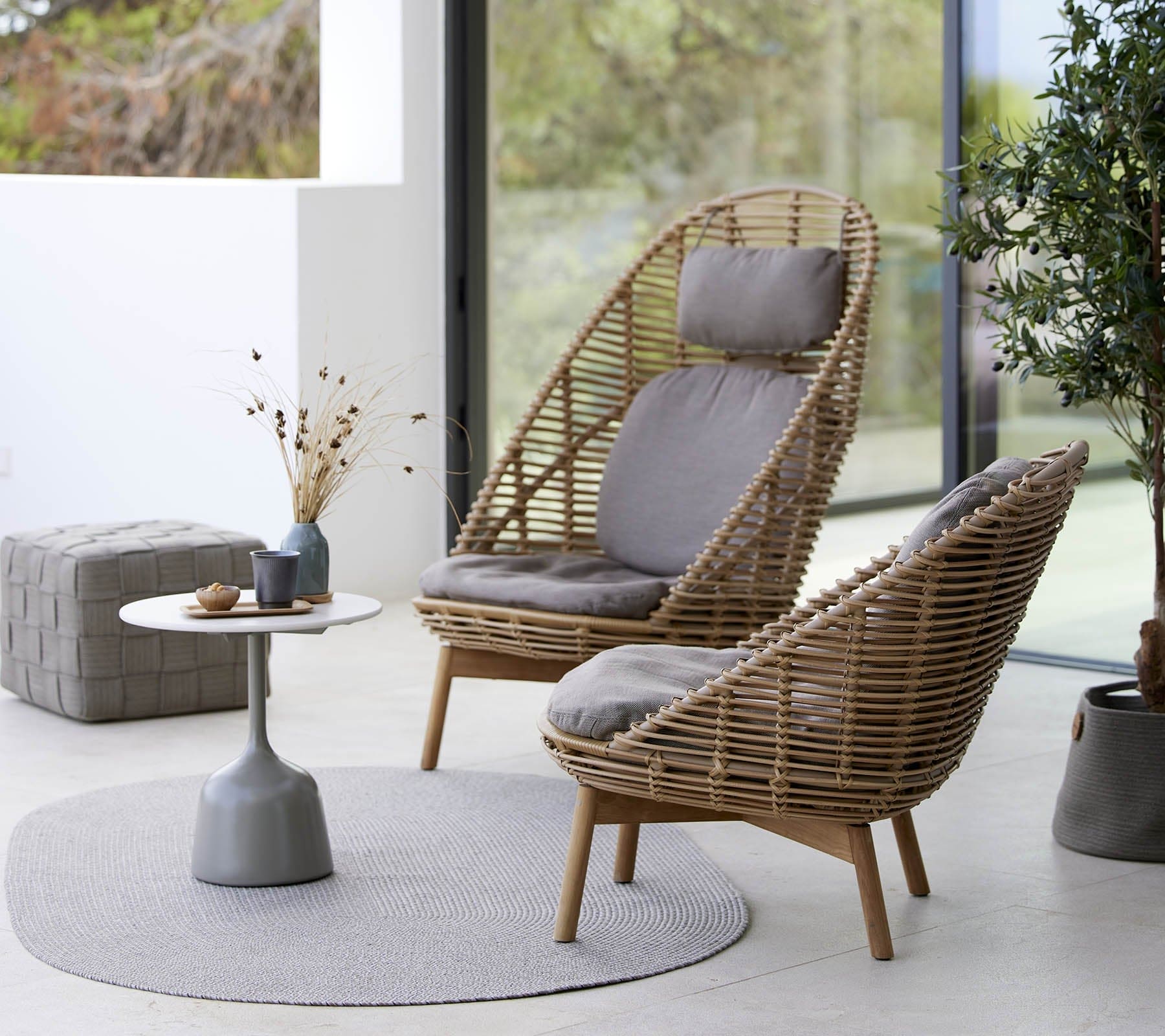Boxhill's Hive Outdoor Lounge Chair lifestyle image with Hive Outdoor Highback Lounge chair and Glaze Outdoor Round Coffee Table