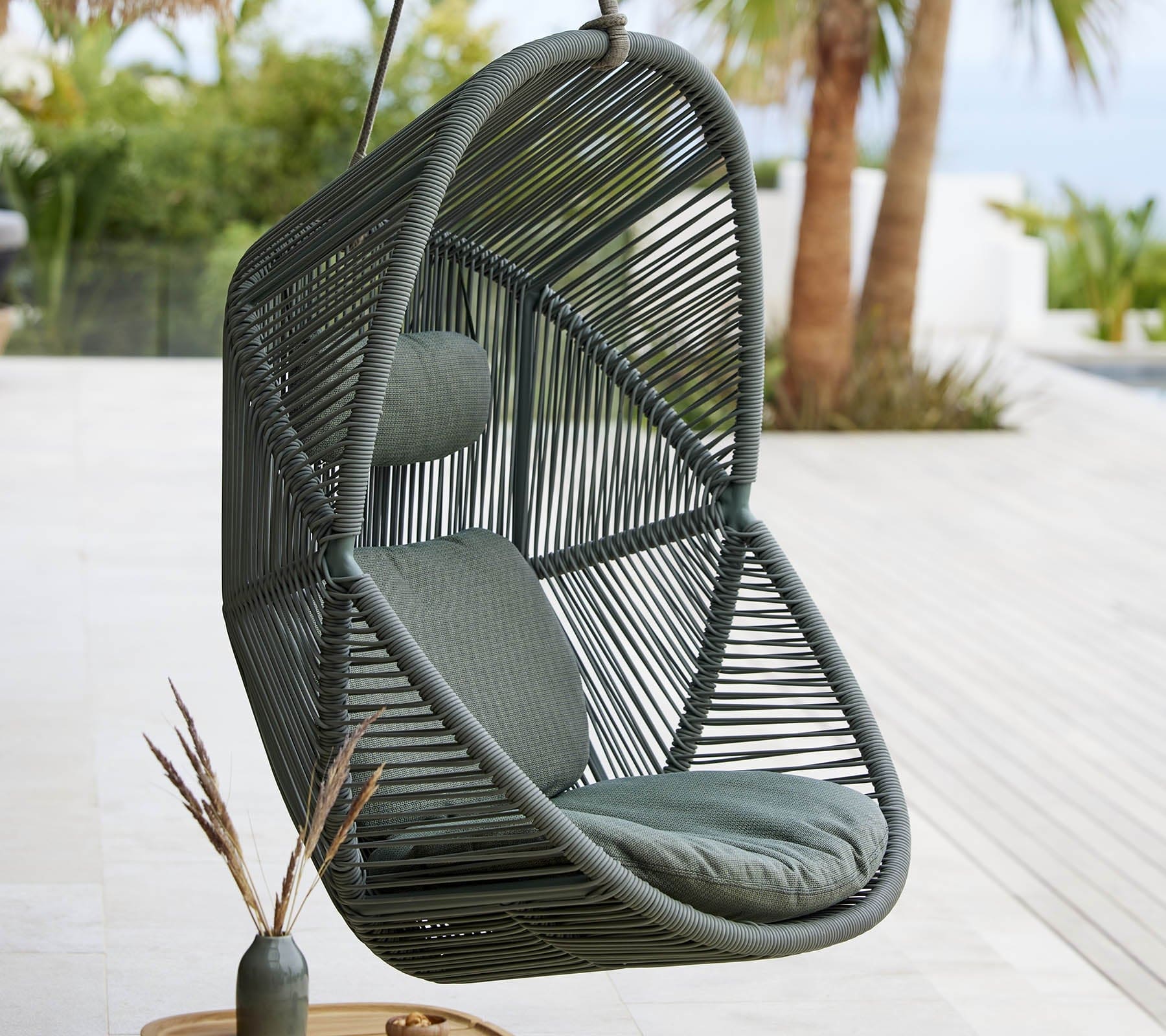 Boxhill's Hive Outdoor Hanging Chair Dusty Green Frame Lifestyle image near poolside