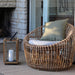 Boxhill's Nest Round Rattan Chair lifestyle image with Lighthouse Outdoor Large Teak Lantern at patio