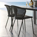 Boxhill's Lean Stackable Outdoor Garden Chair Black Weave lifestyle image with dining table with a bottle of wine, ice bucket and 4 glasses of wine on top