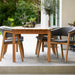 Boxhill's  Luna Outdoor Dining Armchair Lifestyle image with teak dining table