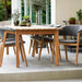 Boxhill's Luna Outdoor Dining Armchair Lifestyle image with teak dining table at patio