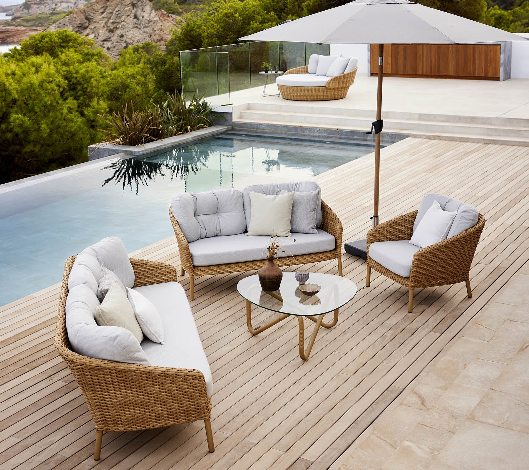 Boxhill's Ocean Large Outdoor Lounge Chair lifestyle image with other Ocean Sofa Collection beside the pool