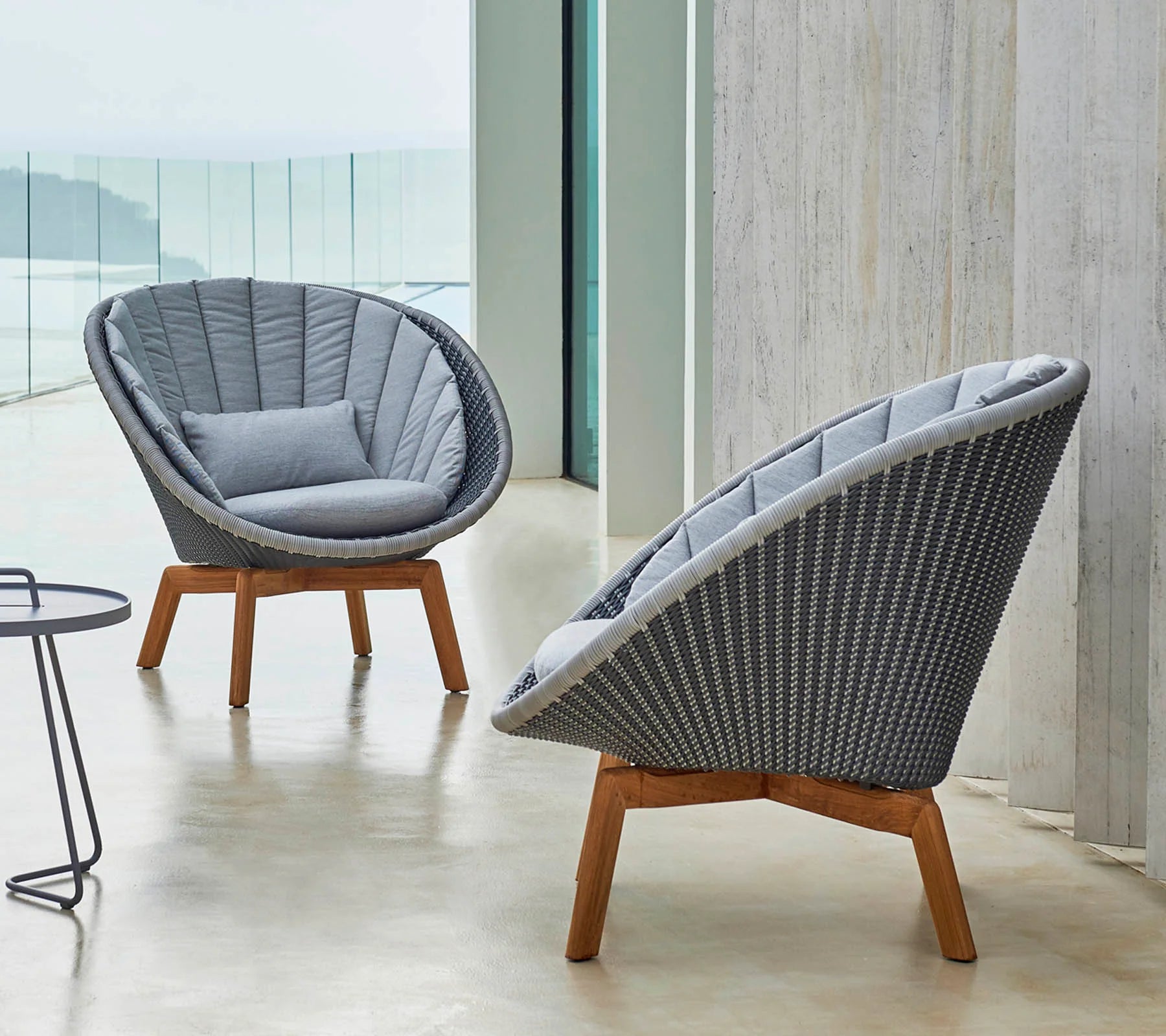 Boxhill's Peacock grey weave outdoor lounge chair with light grey outdoor round side table placed on balcony