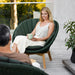 Boxhill's Peacock dark green outdoor lounge chair with a man and a woman sitting on it placed on balcony