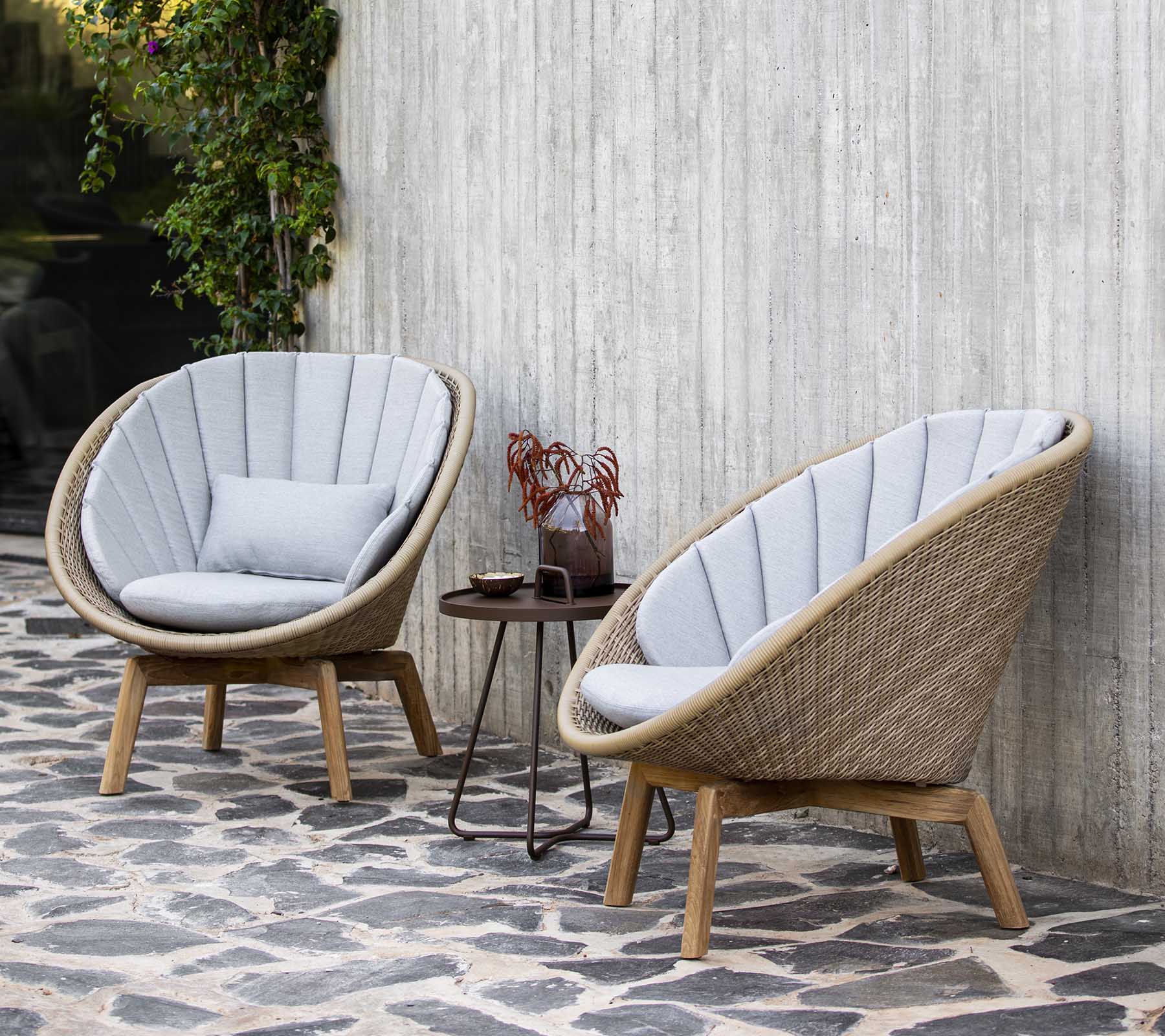 Boxhill's Peacock natural weave outdoor lounge chair with brown outdoor round side table placed in patio