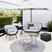 Boxhill's Peacock dark grey outdoor lounge chair with  dark grey outdoor 2-seater sofa and white parasol placed in patio