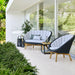 Boxhill's Peacock dark grey outdoor lounge chair with  dark grey outdoor 2-seater sofa placed beside glass wall
