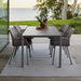 Boxhill's Pure lava grey aluminum outdoor dining table with grey outdoor dining chairs placed on wooden patio