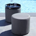  Boxhill's Rest grey outdoor side table | footstool placed on poolside with black round tray and bottle and glass of water on it 