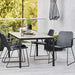 Boxhill's Vision black outdoor dining chair with dark grey outdoor dining table placed on balcony