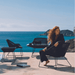 Boxhill's Breeze Outdoor Lounge Chair Black lifestyle image with a woman sitting down