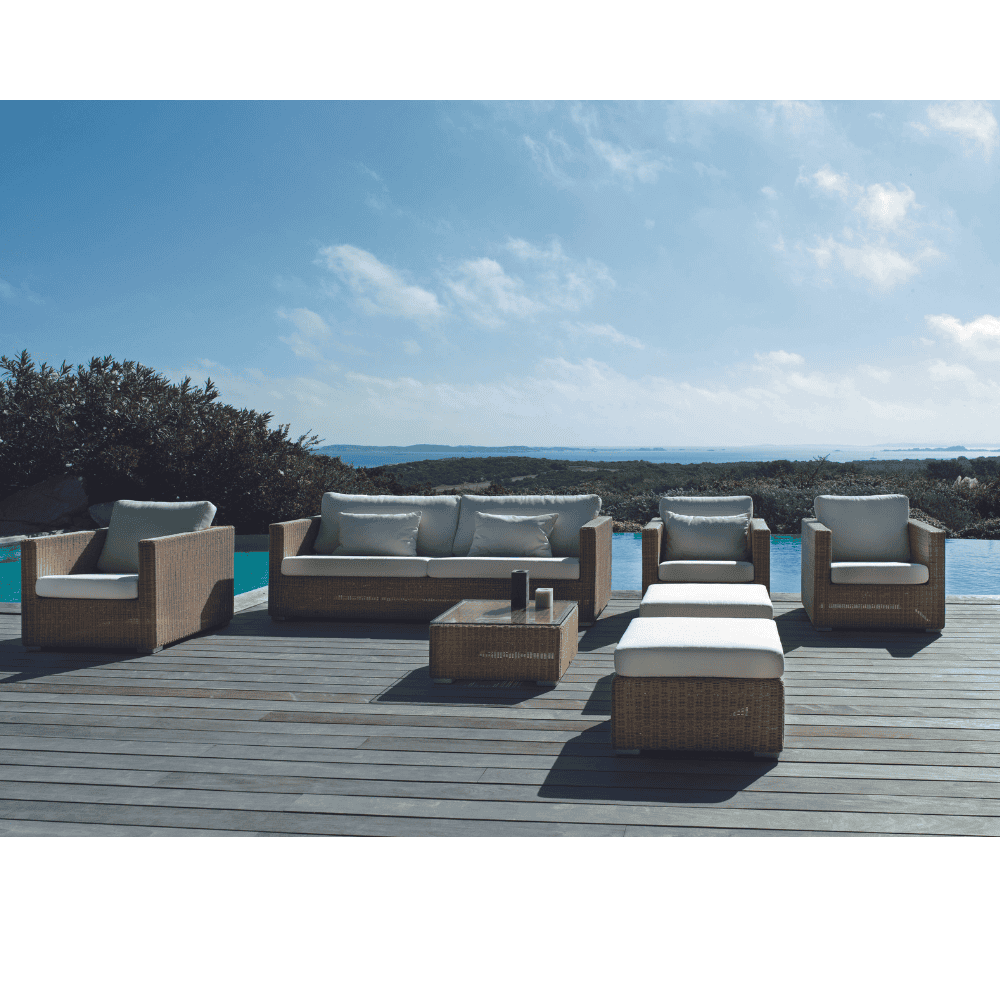 Boxhill's Chester Footstool, Weave Coffee Table Natural lifestyle image with Chester 3-Seater Coastal Sofa and Chester Lounge Weave Coastal Chair on wooden platform poolside
