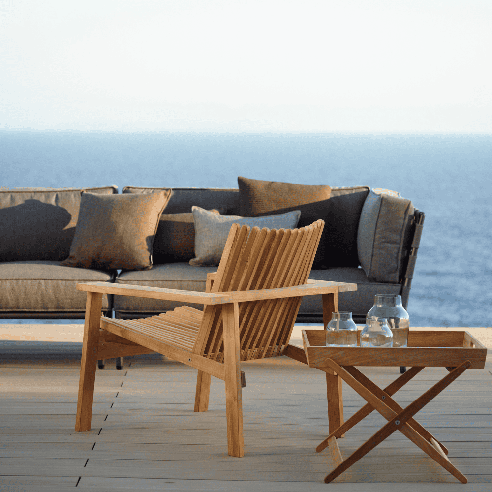 Boxhill's Conic 2-Seater Left Module Sofa lifestyle image on wooden platform at seafront
