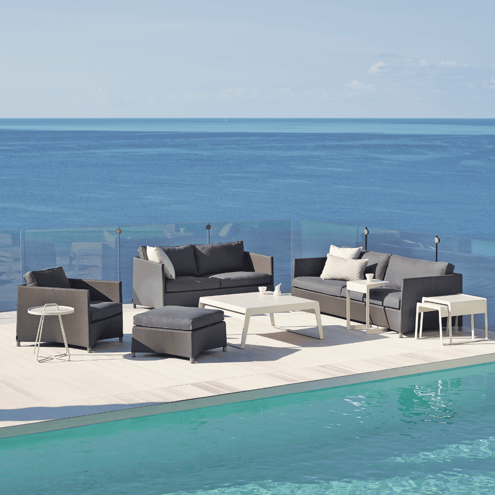 Boxhill's Diamond 2-Seater Weave Sofa lifestyle image with Diamond 3-Seater Weave Sofa, Diamond Weave Lounge Chair and Diamond Weave Footstool beside the pool