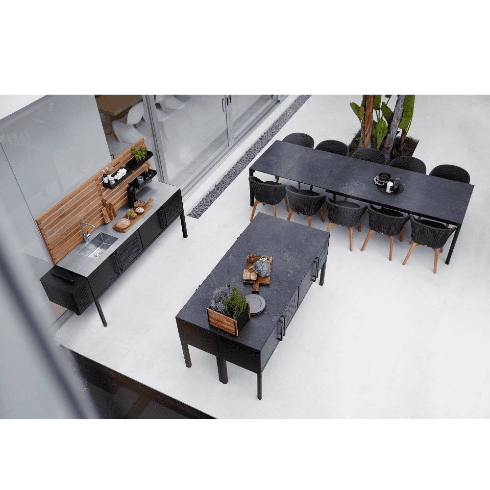 Boxhill's Drop Outdoor Dining Table with 78.8" Table Extension Lava Grey Base Black Tabletop lifestyle image with 10 dining chairs and Drop Outdoor Kitchen Module top view