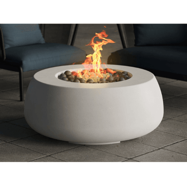 Dune Fire Bowl is a handcrafted outdoor concrete round fire bowl in white with pebble stones by Boxhill