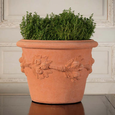Expertly crafted and adorned with the iconic Della Robbia design, the Italian Terracotta Della Robbia Vase is ideal for both indoor and outdoor plants.