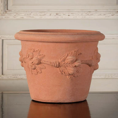 Expertly crafted and adorned with the iconic Della Robbia design, the Italian Terracotta Della Robbia Vase is ideal for both indoor and outdoor plants.