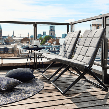  Boxhill's Traveller grey outdoor folding lounge chair with dark blue outdoor round side table placed on balcony