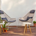 Boxhill's Breeze Highback Outdoor Chair White Grey lifestyle image on wooden platform with Area Coffee Table Chair