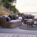 Boxhill's Basket 2-Seater Outdoor Sofa Natural lifestyle image on wooden platform