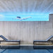 Boxhill's Relax dark grey outdoor chaise lounge placed on poolside with a view of a woman swimming under the water