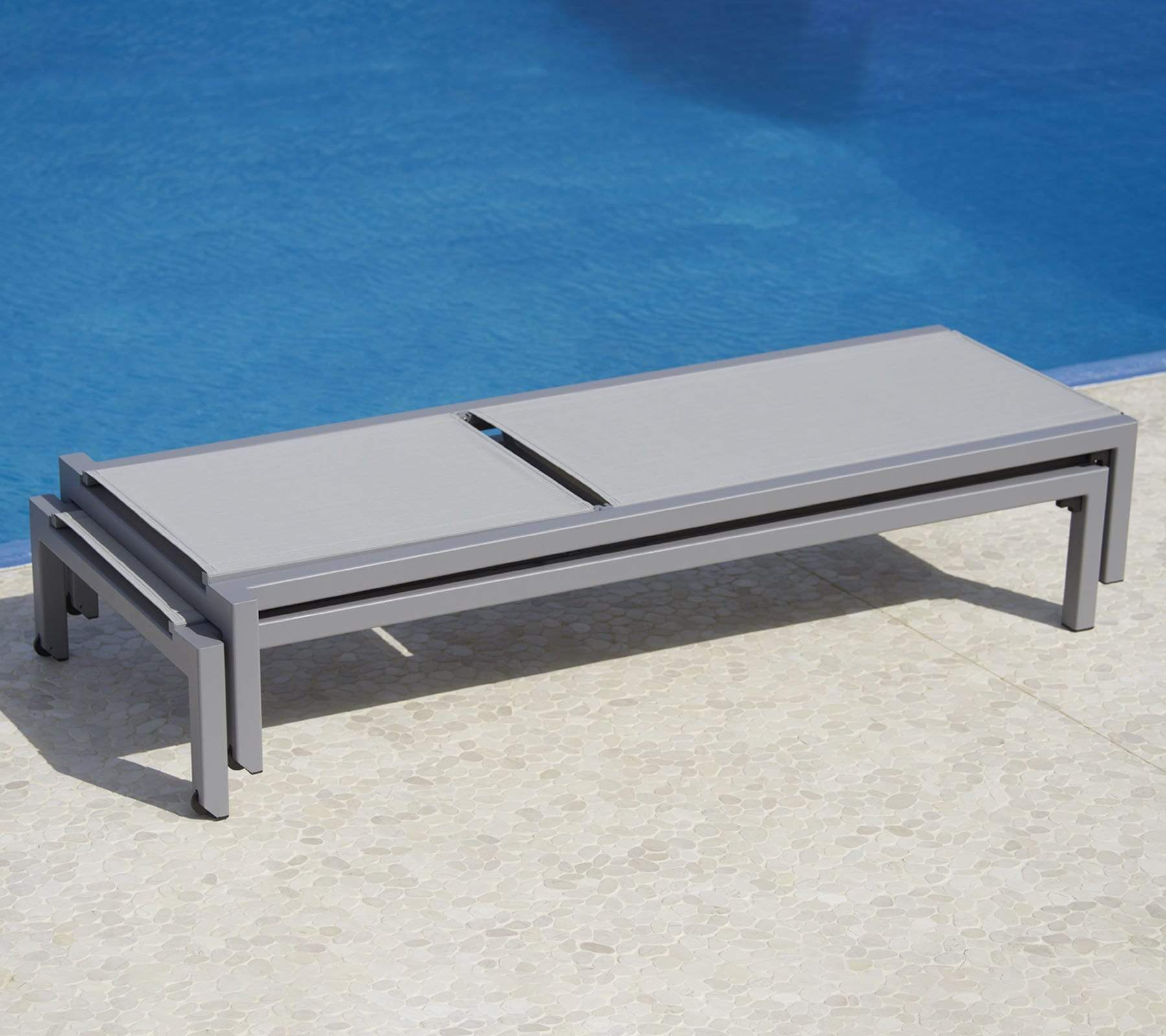 Boxhill's Relax  grey outdoor chaise lounge piled up without cushion placed beside the pool