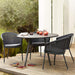  Boxhill's Trinity dark grey outdoor stackable chair with dark grey round dining table placed on wooden platform