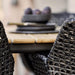 Boxhill's Vibe black outdoor armchair close up view with teak outdoor table