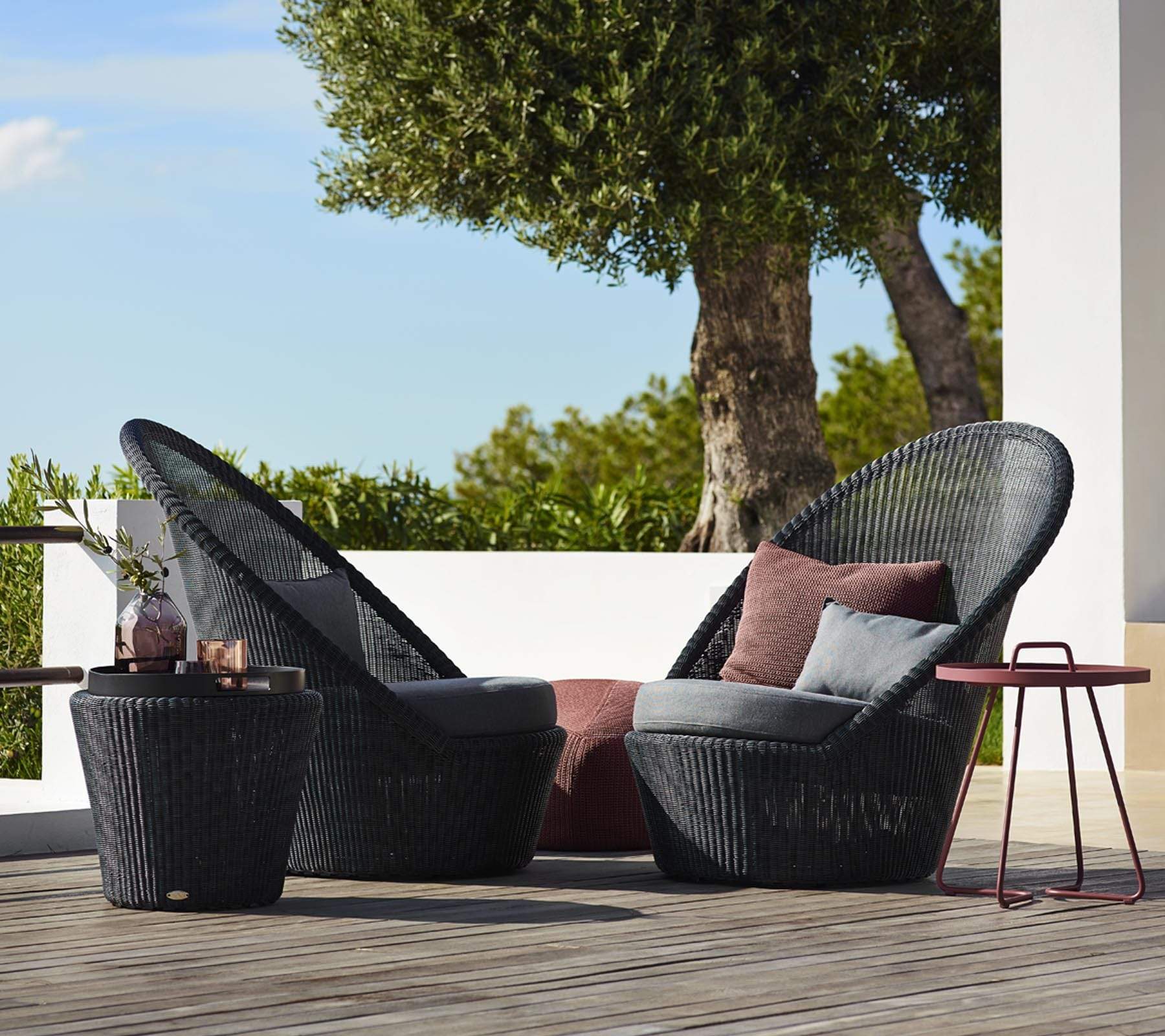 Boxhill's Kingston Outdoor Footstool | Side Table lifestyle image with Kingston Sunchair Lounge with Wheels and a small red round table at patio