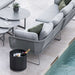   Boxhill's lava grey outdoor round small modern planter box with light grey outdoor sectional sofa placed beside the pool