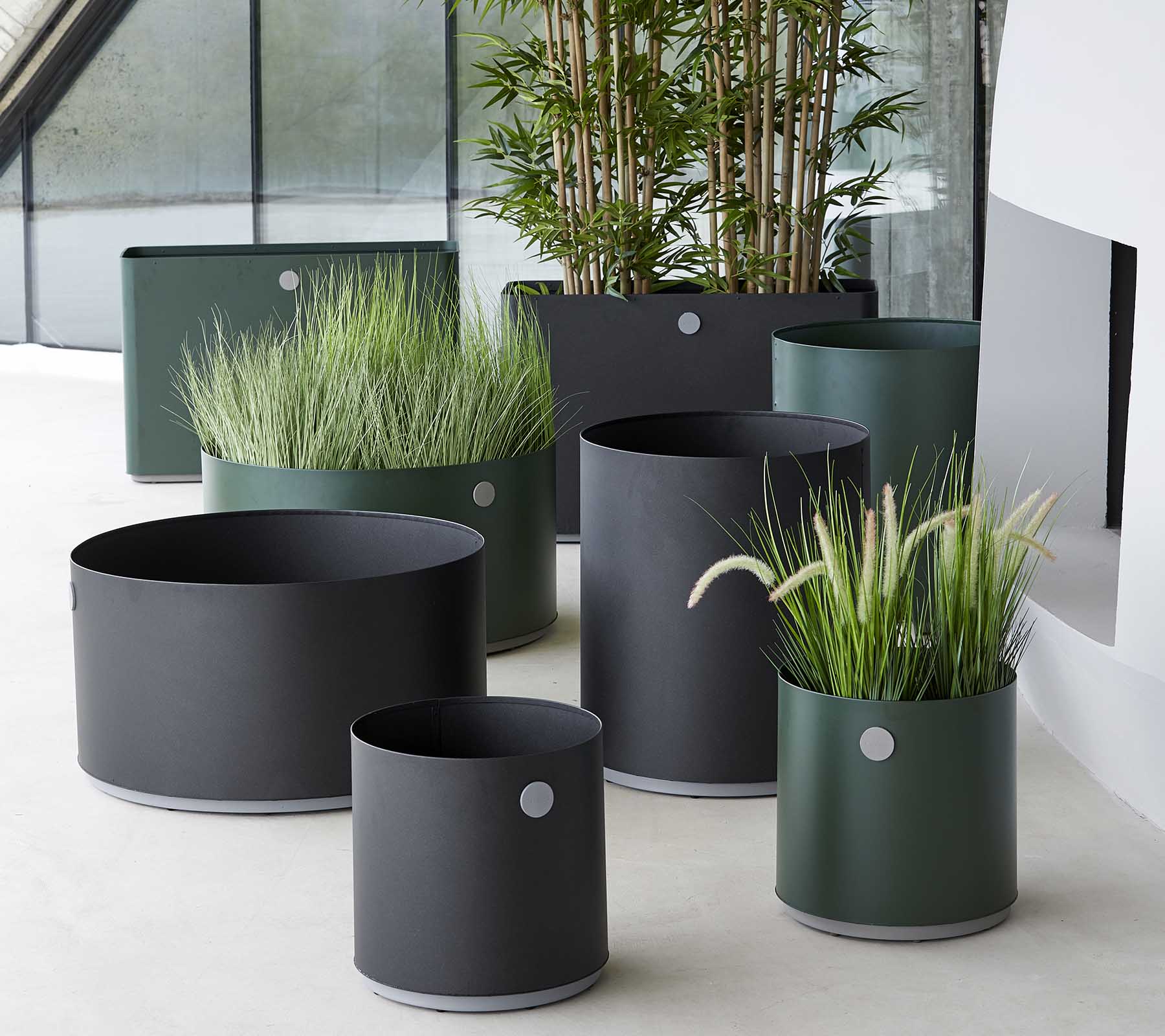 Boxhill's lava grey and dark green outdoor round large modern planter box with rectangular modern planter box placed in patio