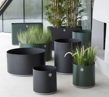 Boxhill's lava grey and dark green outdoor round medium modern planter box with large round and rectangular modern planter box placed in patio