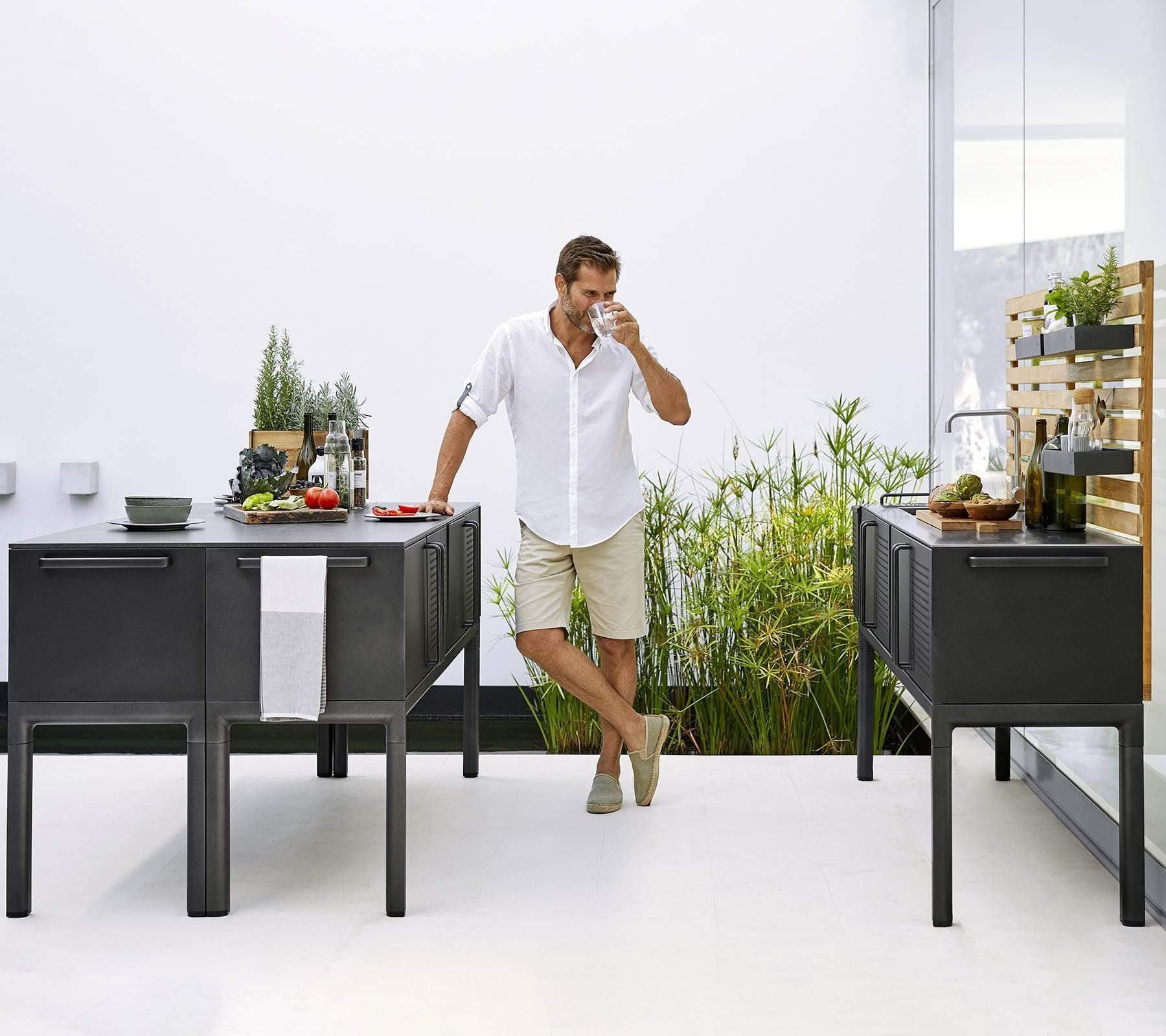 Boxhill's Drop Outdoor Kitchen Module with 3 Shelves lifestyle image with a man on white shirt drinking water