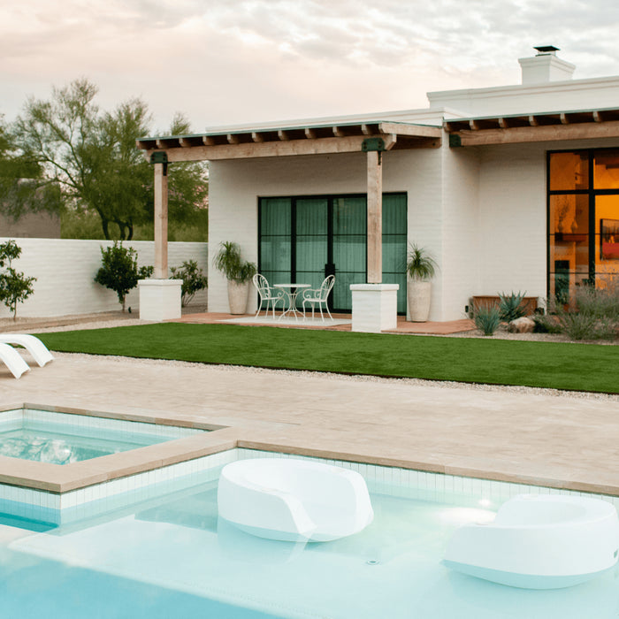 Backyard pool area designed by Elizabeth Przygoda of Boxhill Design features Splash Moon In-Pool Chairs on tanning ledge.