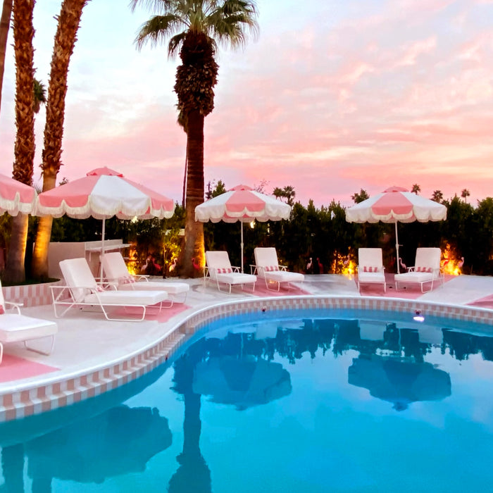 Palm spring modern pool design with umbrellas, sunloungers beside the pool