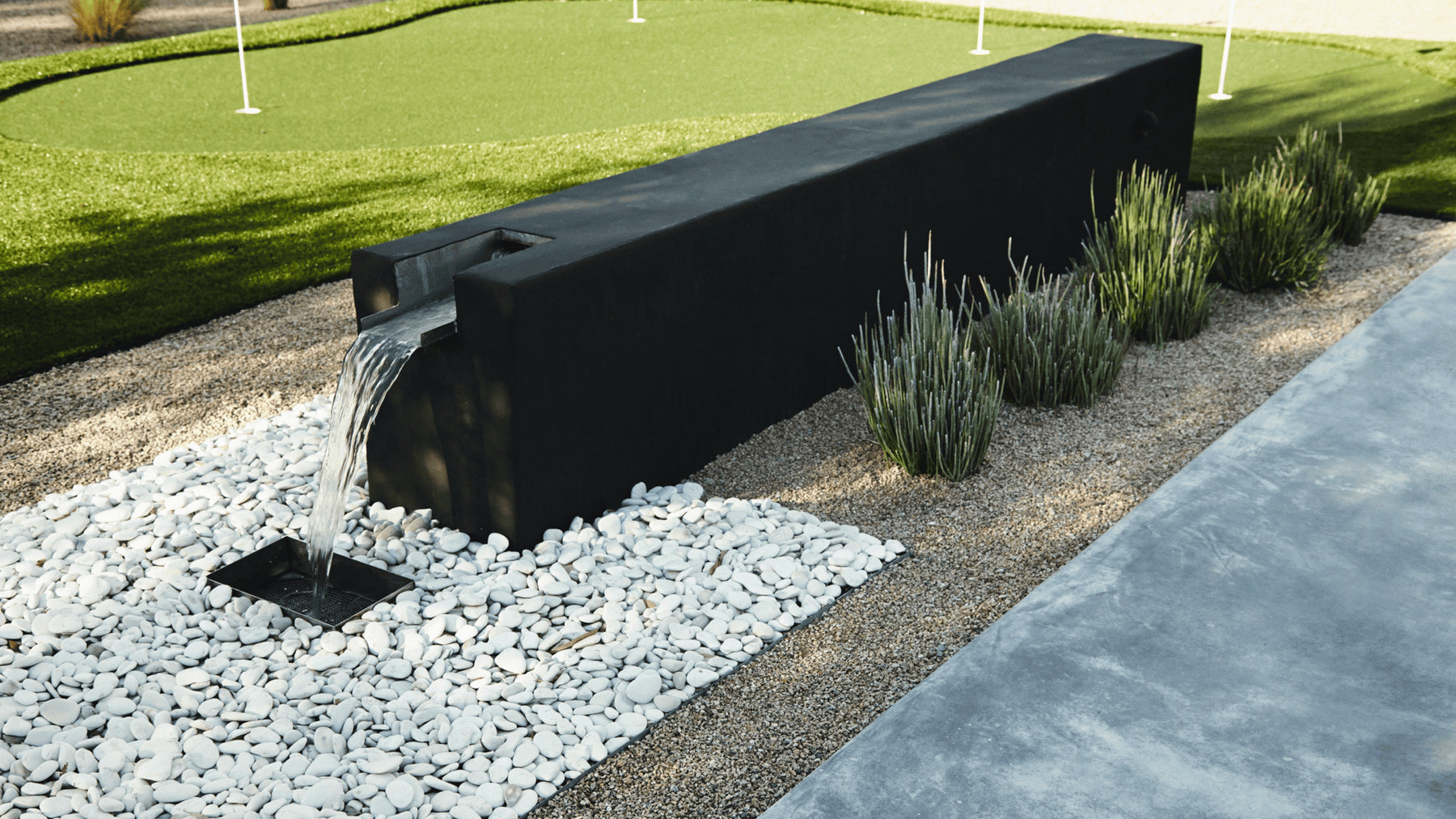 Boxhill design custom water feature in modern backyard garden.